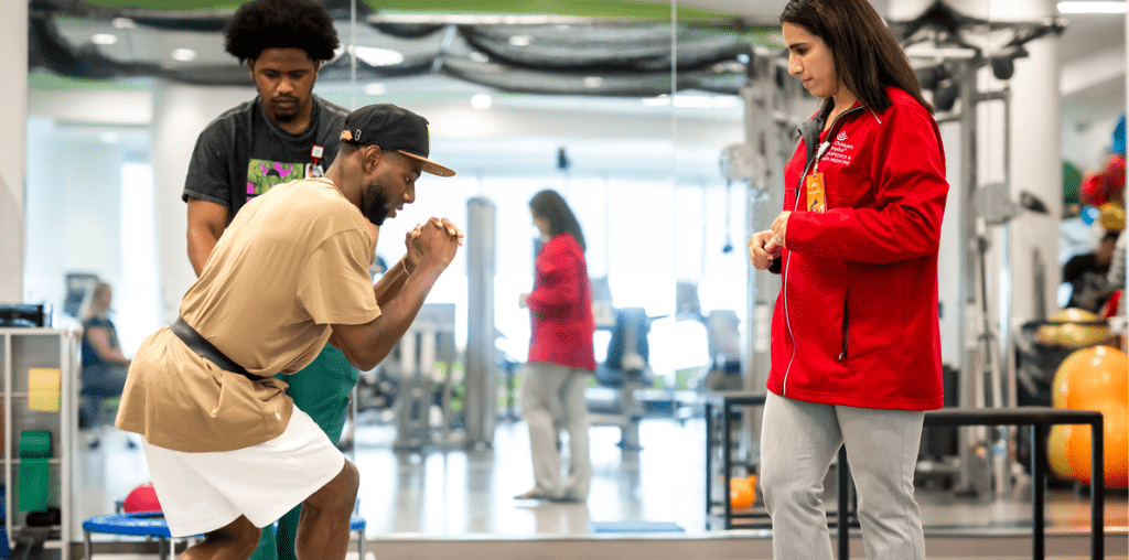 Jennifer Morgan supports Team USA breakdancer Jeffrey Louis during a physical therapy session.