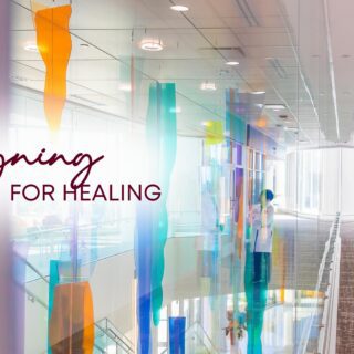 Glass artwork in a corridor of the Texas Children's North Austin Campus with text that reads Designing for Healing.